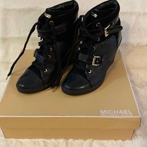 Black Michael Kors lace up leather booties.